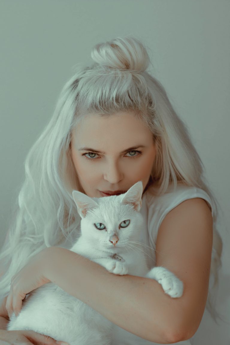 Blond woman with white cat